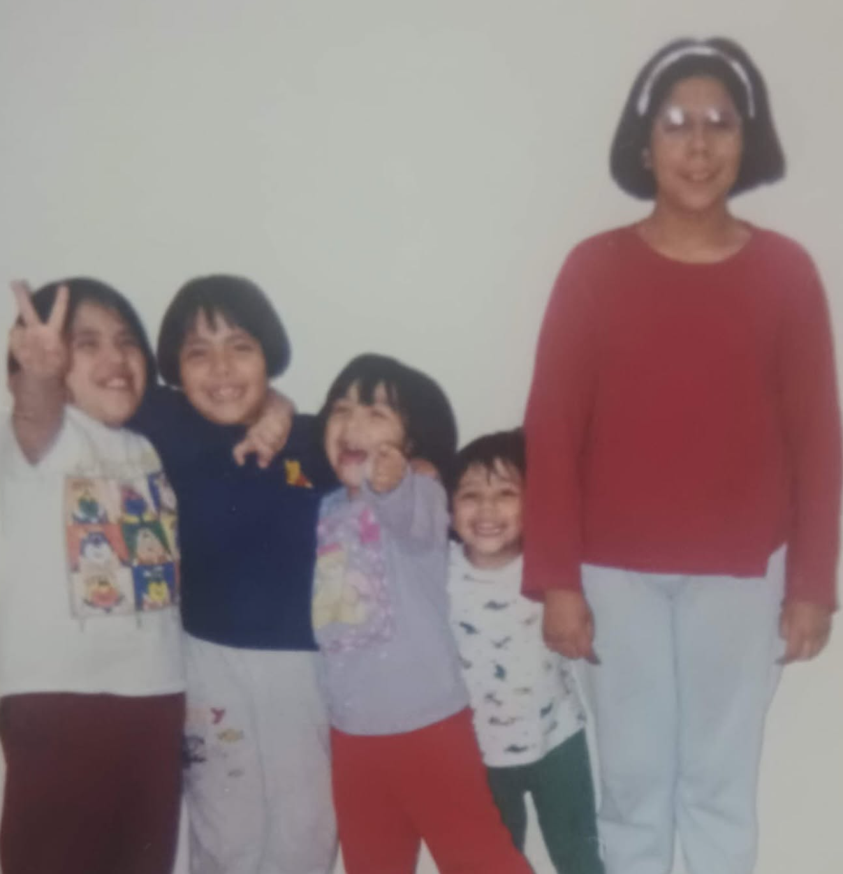 Angela as a child, the fourth sister, with her siblings
